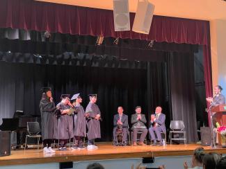 2023 graduates on stage at commencement