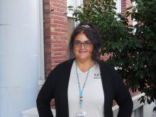 Leslie is standing outside of the Old main building smiling