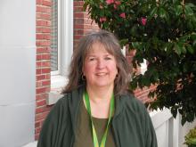 Laurie standing outside of the Old Main building