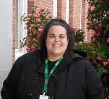 Jennifer is standing outside of the Old Main building smiling