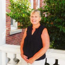 Melissa standing outside of Old Main smiling